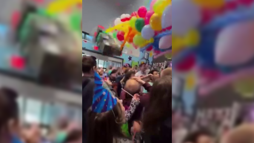 A still from a spectator's video showing the moment 10 people were hurt when a Lego display fell onto a crowd, including children, at a New Year's event at a Peabody, Massachusetts, arcade on Tuesday.