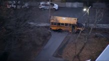 A school bus on a sidewalk by the Mary Curley School in Boston's Jamaica Plain neighborhood on Friday, Dec. 6, 2024.