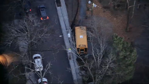 A school bus on a sidewalk by the Mary Curley School in Boston's Jamaica Plain neighborhood on Friday, Dec. 6, 2024.