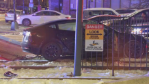 A crashed Tesla on Green Line tracks in Boston Monday, Dec. 23, 2024.