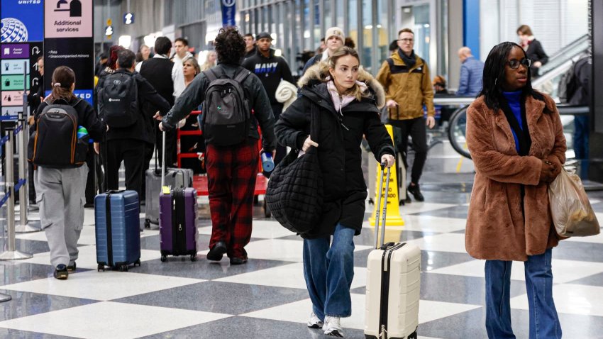 Travelers walk through O’Hare International Airport in Chicago on Dec. 20, 2024.