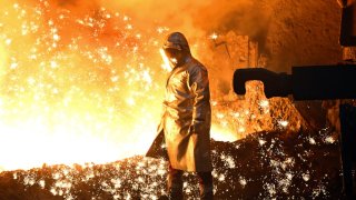 An employee stands at a blast furnace. In November, Thyssenkrupp Steel announced that the number of jobs in the steel sector would be reduced by 11,000 to 16,000 within six years. 