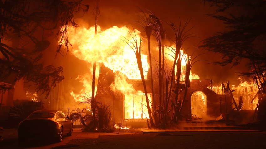 Fire engulfs a home as the Eaton Fire moves through the area on January 08, 2025 in Altadena, California. 