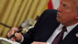 U.S. President Donald Trump signs documents as he issues executive orders in the Oval Office at the White House on Inauguration Day in Washington, U.S., Jan. 20, 2025. 