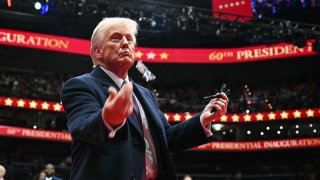 President Donald Trump throws pens to the crowd after signing executive orders during the inaugural parade inside Capital One Arena, in Washington, DC, on January 20, 2025. 