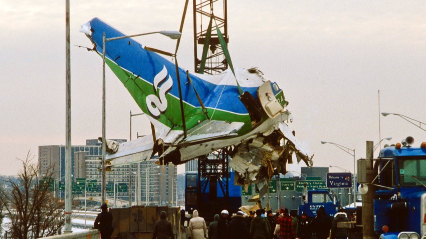 View along a bridge as a section of Air Florida Flight 90 is lifted