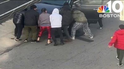 WATCH: Group of people helps woman pinned under vehicle in Lawrence