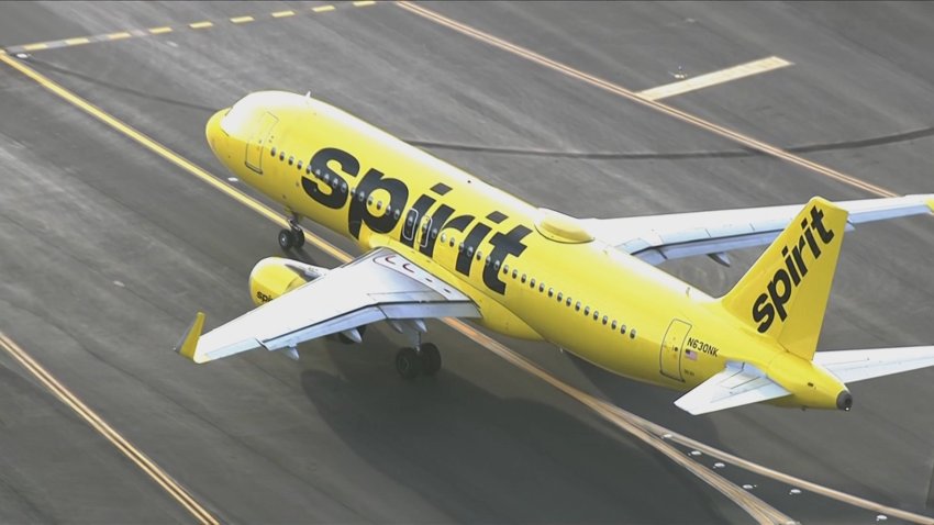 A Spirit airplane on a taxiway.