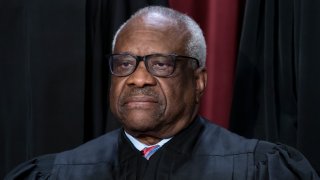 FILE – Associate Justice Clarence Thomas joins other members of the Supreme Court as they pose for a group portrait in Washington, Oct. 7, 2022.