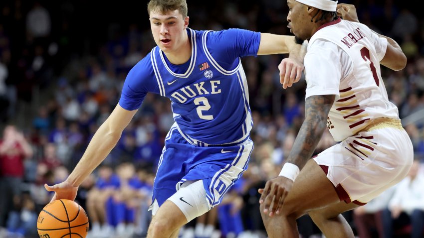 Duke guard Cooper Flagg (2) dribbles around Boston College guard Roger McFarlane (3) during the first half of an NCAA college basketball game Saturday, Jan. 18, 2025, in Boston. (AP Photo/Mark Stockwell)