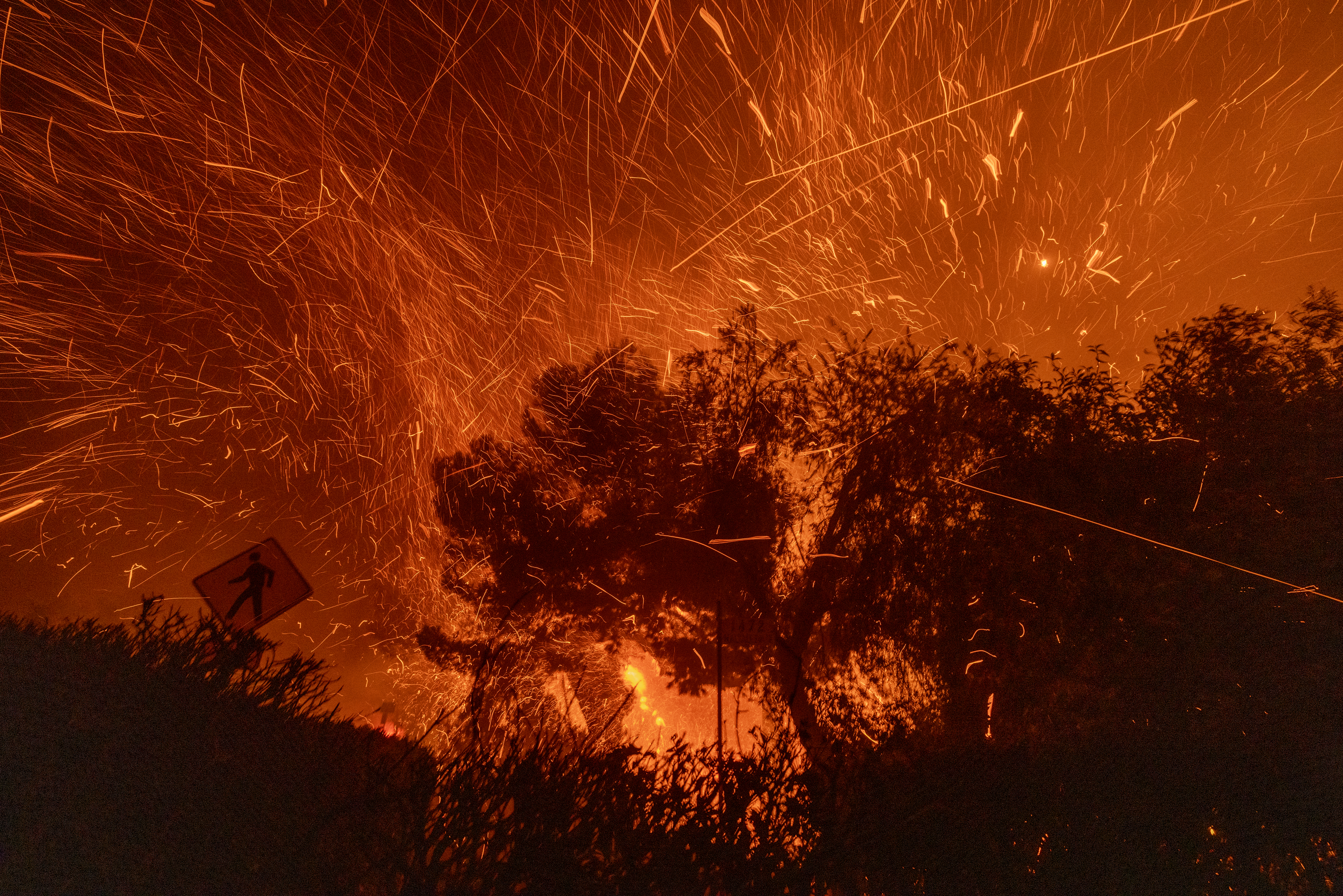 Strong winds blow embers from homes burning in the Eaton Fire on Jan. 7, 2025 in Pasadena.