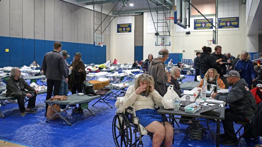 Evacuees from the Palisades fire are seen at an evacuation and shelter center at Westwood Recreation Center in Los Angeles, California, on January 8, 2025. A ferocious wildfire in a Los Angeles suburb devoured buildings and sparked panicked evacuations January 7, as hurricane-force winds tore through the region. More than 200 acres (80 hectares) was burning in Pacific Palisades, a upscale spot with multi-million dollar homes in the Santa Monica Mountains. Across town, on the northern edge of Los Angeles, another fire broke out in Eaton Canyon, near Pasadena, quickly consuming 200 acres (81 hectares) later in the night, according to Angeles National Forest officials. (Photo by Agustin PAULLIER / AFP) (Photo by AGUSTIN PAULLIER/AFP via Getty Images)