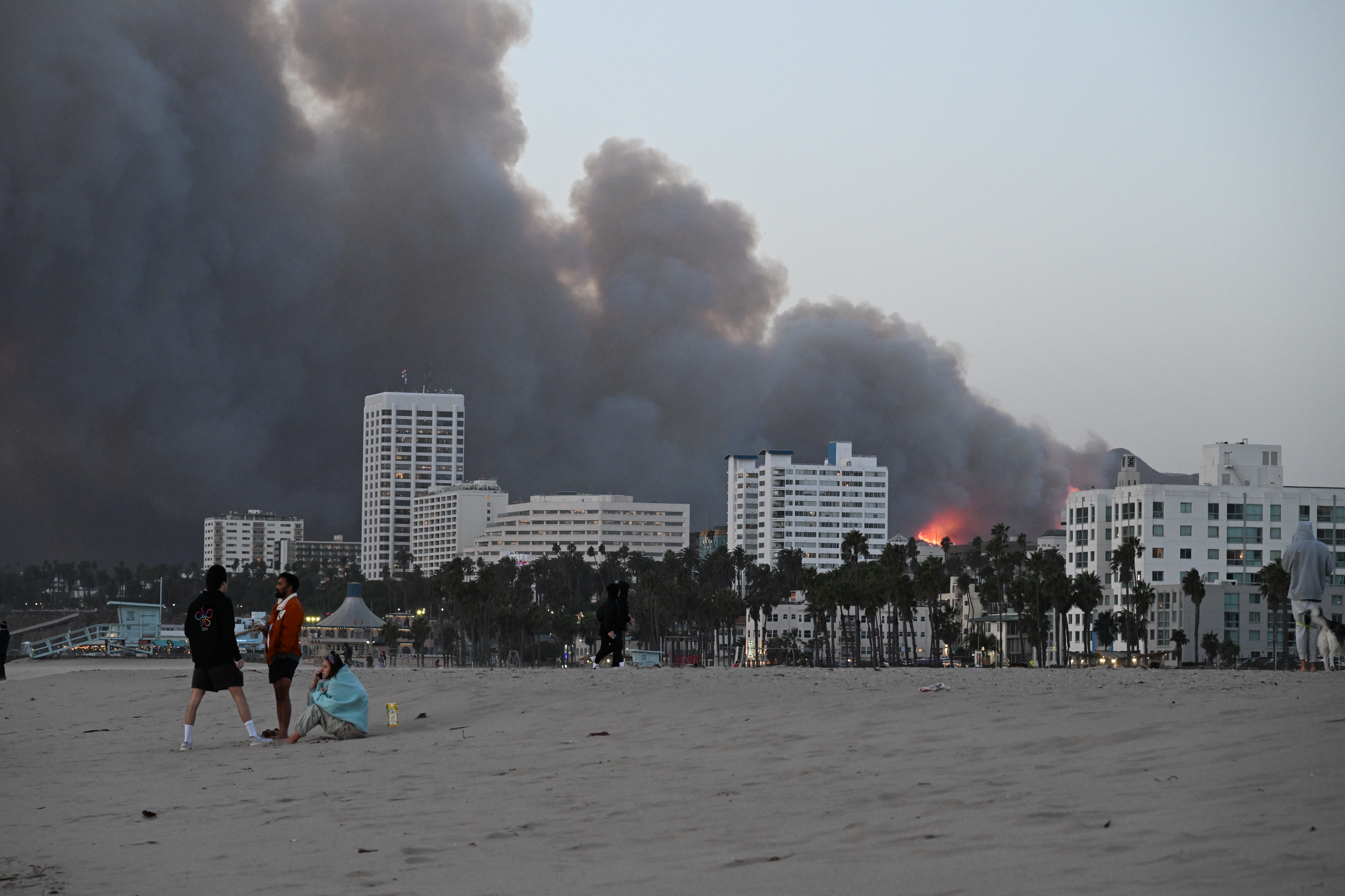 Smoke and fire from the Palisades Fire fills the Santa Monica skyline as seen from Santa Monica Beach on Jan. 7, 2025.