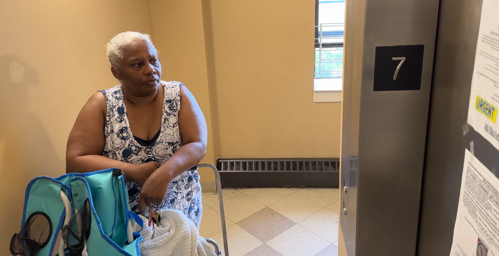 Sheila Thompson waits for an elevator at the Ruth Barkley Apartments in Boston's South End.