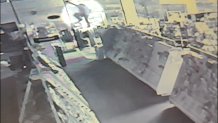 Police say surveillance footage shows a thief breaking into a local business through the ceiling.