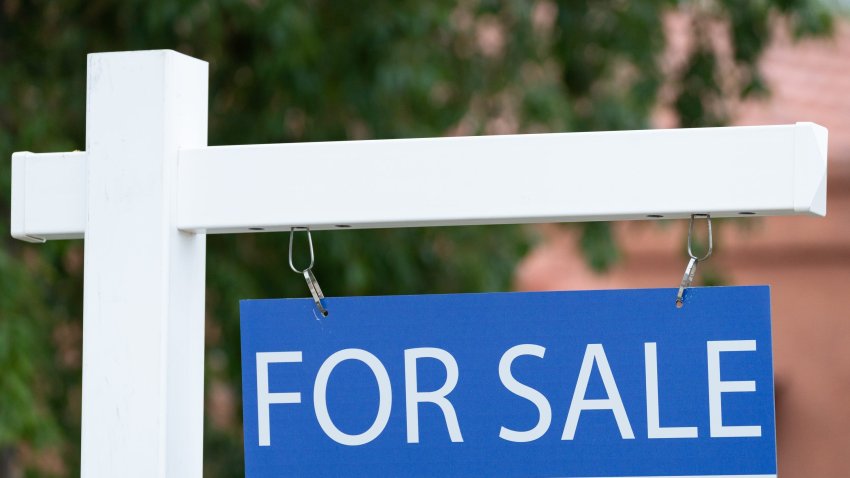 A for sale sign is pictured outside a home.