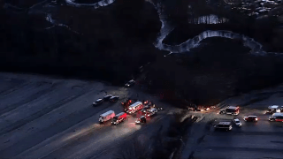 A large number of first responders at a parking lot near an icy stream in Sudbury, Massachusetts, on Wednesday, Jan. 8, 2025.