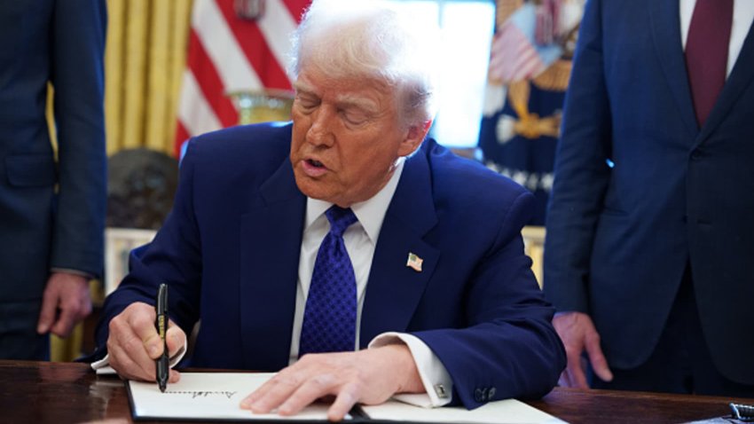 U.S. President Donald Trump signs an executive order establishing the Energy Dominance Council led by Secretary of the Interior Doug Burgum in the Oval Office at the White House on February 14, 2025 in Washington, DC. President Trump signed a second executive order withholding federal funding from schools and universities that impose a COVID-19 vaccine mandate.