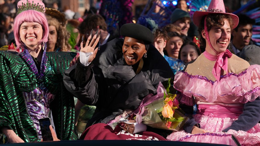 Cynthia Erivo rides with two character actors during a parade in her honor