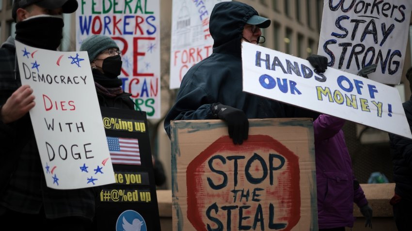 Protesters rally outside of the Theodore Roosevelt Federal Building headquarters of the U.S. Office of Personnel Management