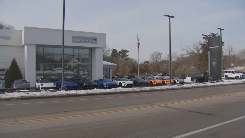 A McLaren dealership in Norwell, Massachusetts, that was allegedly threatened by a man also suspected of trying to carjack an Uber car and a police cruiser.