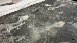Hateful messages were seen written on the ground at Tesla charging station in Tyngsborough, Massachusetts, on Tuesday, Feb. 12, 2025. Two swastikas have been blurred.
