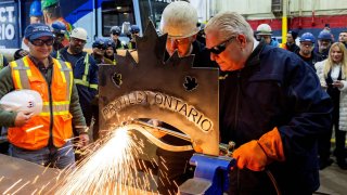 Ontario Premier Doug Ford cuts a decorative piece of steel with the words “PROTECT ONTARIO” while touring Heddle Shipyards, a ship repair and construction company in St. Catharines, Ontario, Canada, January 31, 2025.