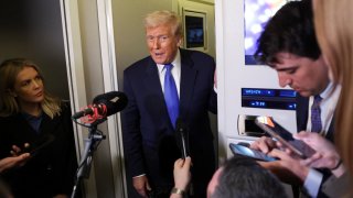 U.S. President Donald Trump speaks to reporters as White House Press Secretary Karoline Leavitt stands by him aboard Air Force One on his return to Washington, D.C., U.S., March 9, 2025. 