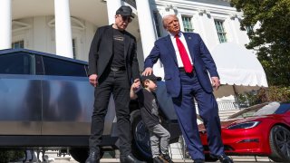 U.S. President Donald Trump talks to the media, next to Tesla CEO Elon Musk with his son X Æ A-12, at the White House in Washington, D.C., U.S., March 11, 2025. 