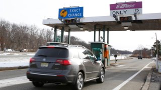 Car approaching the entrance to the Garden State Parkway in Paramus are required to pass thru the E-ZPass toll booth.