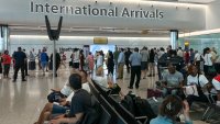 FILE - Travelers at Heathrow airport, in London