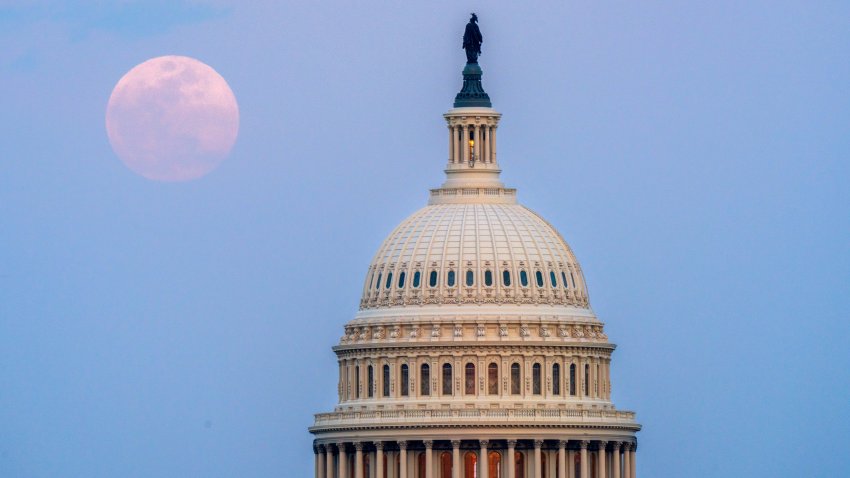 WASHINGTON, DC – MARCH 13: The Full Worm Moon rises behind the U.S. Capitol dome at dusk on March 13, 2025, in Washington, DC. (Photo by J. David Ake/Getty Images)