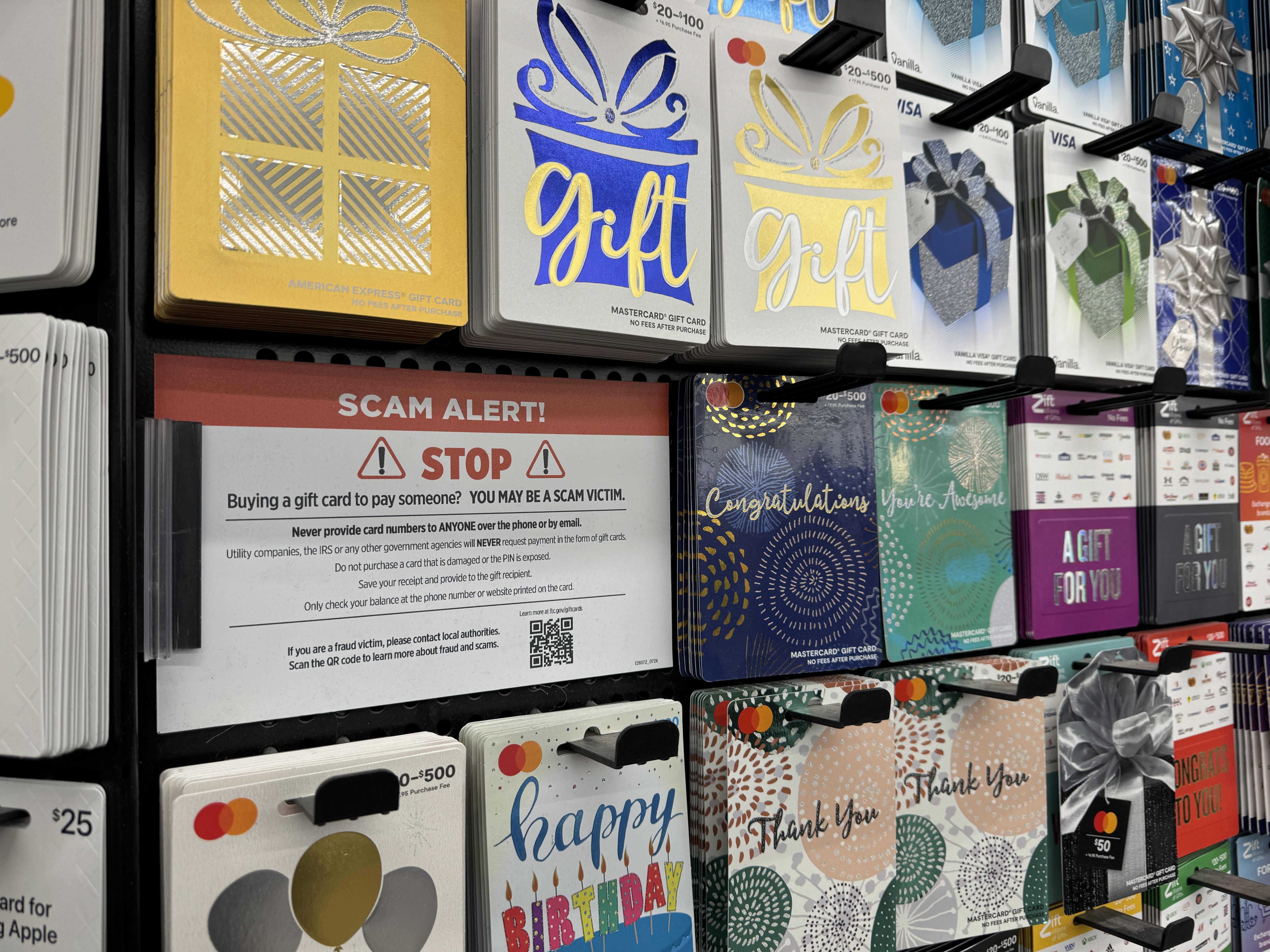 A gift card scam warning at a store.
