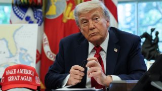 U.S. President Donald Trump looks on next to wounded veterans (not pictured) before signing executive orders in the Oval Office at the White House in Washington, D.C., U.S., April 23, 2025.