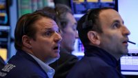 Traders work on the floor at the New York Stock Exchange on April 24, 2025.