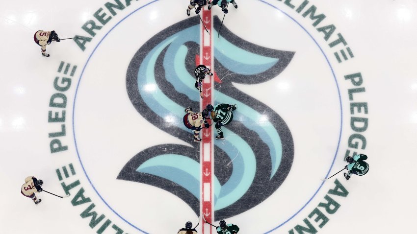 Marie-Philip Poulin takes a faceoff against Susanna Tapani in Seattle