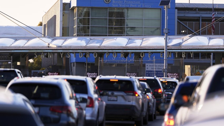 FILE - Vehicles wait in line to cross the border into the United States at the San Ysidro Port of Entry, Tuesday, March 18, 2025, in Tijuana, Mexico.