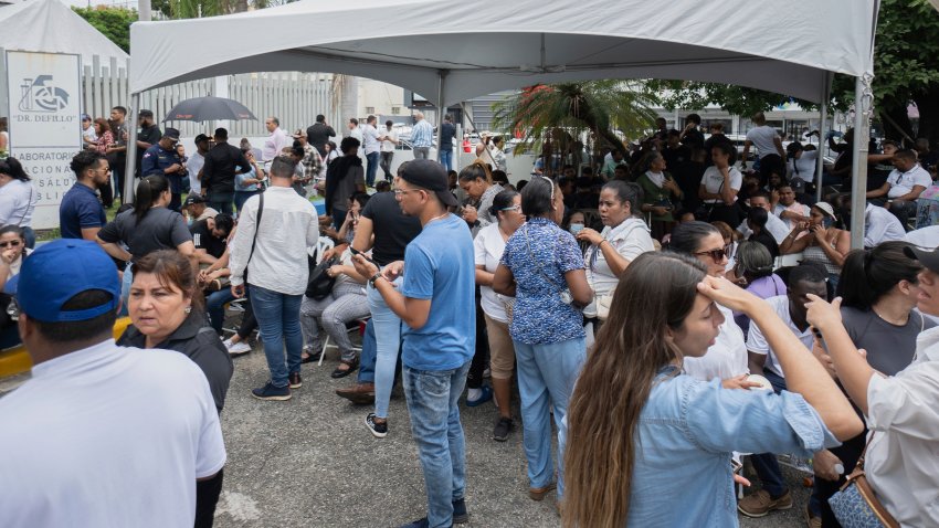 Family members wait to identify the remains of their loved who died when the roof collapsed at the Jet Set nightclub during a merengue concert, in a parking lot of the National Institute of Forensic Pathology in Santo Domingo, Dominican Republic, Wednesday, April 9, 2025