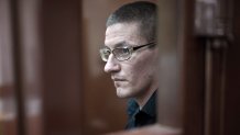 FILE - Robert Woodland, a Russia-born U.S. citizen, stands in a glass cage during a court hearing, July 4, 2024, in Moscow, Russia. (AP Photo/Alexander Zemlianichenko, File)