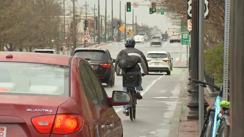 A biker travels through Boston using a designated bike lane.