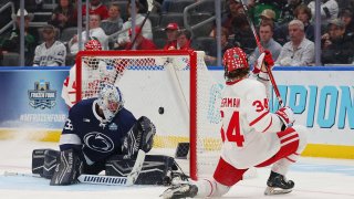 Cole Eiserman #34 of the Boston University Terriers scores a goal against Arsenii Sergeev #35 of the Penn State Nittany Lions in the second period at Enterprise Center on April 10, 2025 in St Louis, Missouri.