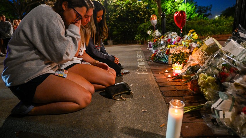 Students hold a vigil near the scene of a shooting near the Florida State University