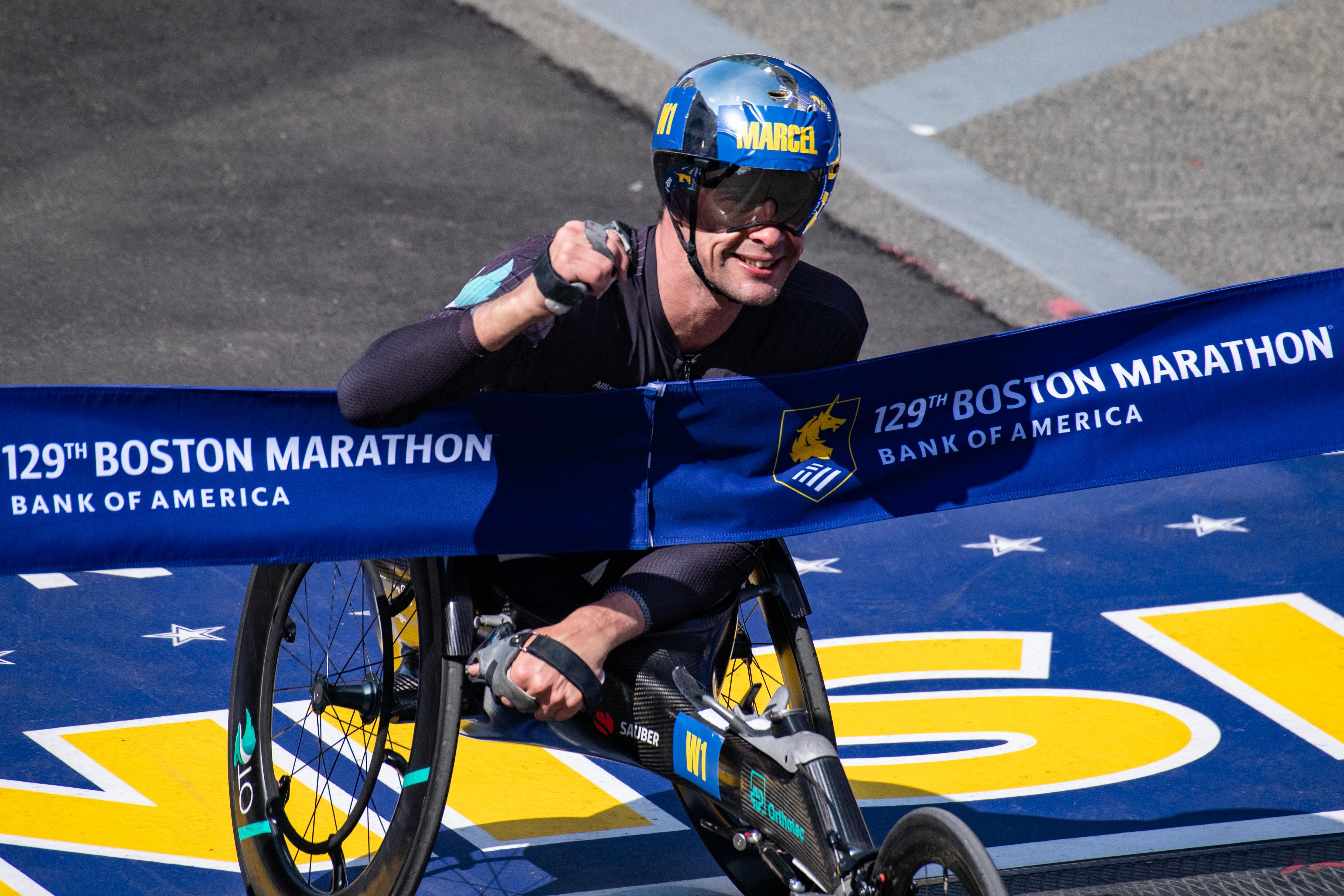 Swiss athlete Marcel Hug crosses the finish line as he finishes in first place in the men&#8217;s wheelchair division during the 129th Boston Marathon in Boston, Massachusetts on April 21, 2025. The marathon includes around 30,000 athletes from 129 countries running the 26.2 miles from Hopkinton to Boston, Massachusetts.  The event is the world&#8217;s oldest annually run marathon. (Photo by Joseph Prezioso / AFP) (Photo by JOSEPH PREZIOSO/AFP via Getty Images)