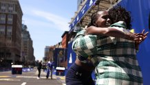 BOSTON, MA - April 21: Women's winner Sharon Lokedi embraces her mother, Rose, after crossing the finish line of the 129th Boston Marathon on April 21, 2025. (Photo by Jessica Rinaldi/The Boston Globe via Getty Images)