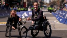 BOSTON, MASSACHUSETTS - APRIL 21: (L-R) Susannah Scaroni of the United States and Marcel Hug of Switzerland pose with their trophies after winning the 129th Boston Marathon Wheelchair on April 21, 2025 in Boston, Massachusetts. (Photo by Maddie Meyer/Getty Images)