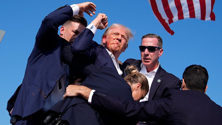 FILE - Then-candidate former President Donald Trump is surrounded by U.S. Secret Service agents at a campaign rally, July 13, 2024, in Butler, Pa.