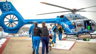 Hiedi Noland, Critical Care Transport Nurse transports a trauma patient aboard a Boston MedFlight transport helicopter.