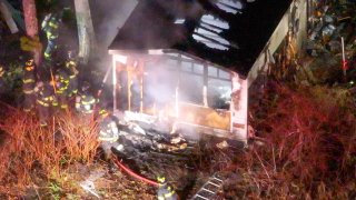 Firefighters at the scene of a deadly fire in Wareham, Massachusetts, on Friday, April 11, 2025.