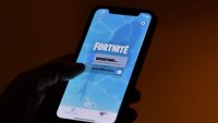 This illustration picture shows a person waiting for an update of Epic Games’ Fortnite on their smartphone in Los Angeles on August 14, 2020.