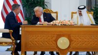 U.S. President Donald Trump, Qatar’s Emir Tamim bin Hamad Al Thani and Boeing CEO Kelly Ortberg attend a signing ceremony in Doha, Qatar, May 14, 2025.